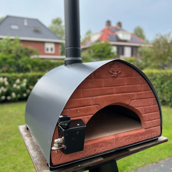 Outdoor brick oven on a stand with a residential background